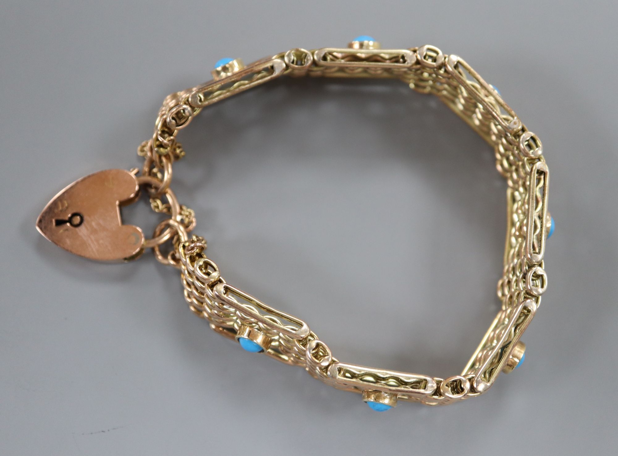 An early 20th century 9ct and seven stone turquoise set gatelink bracelet, approx. 18cm, gross 18.8 grams.